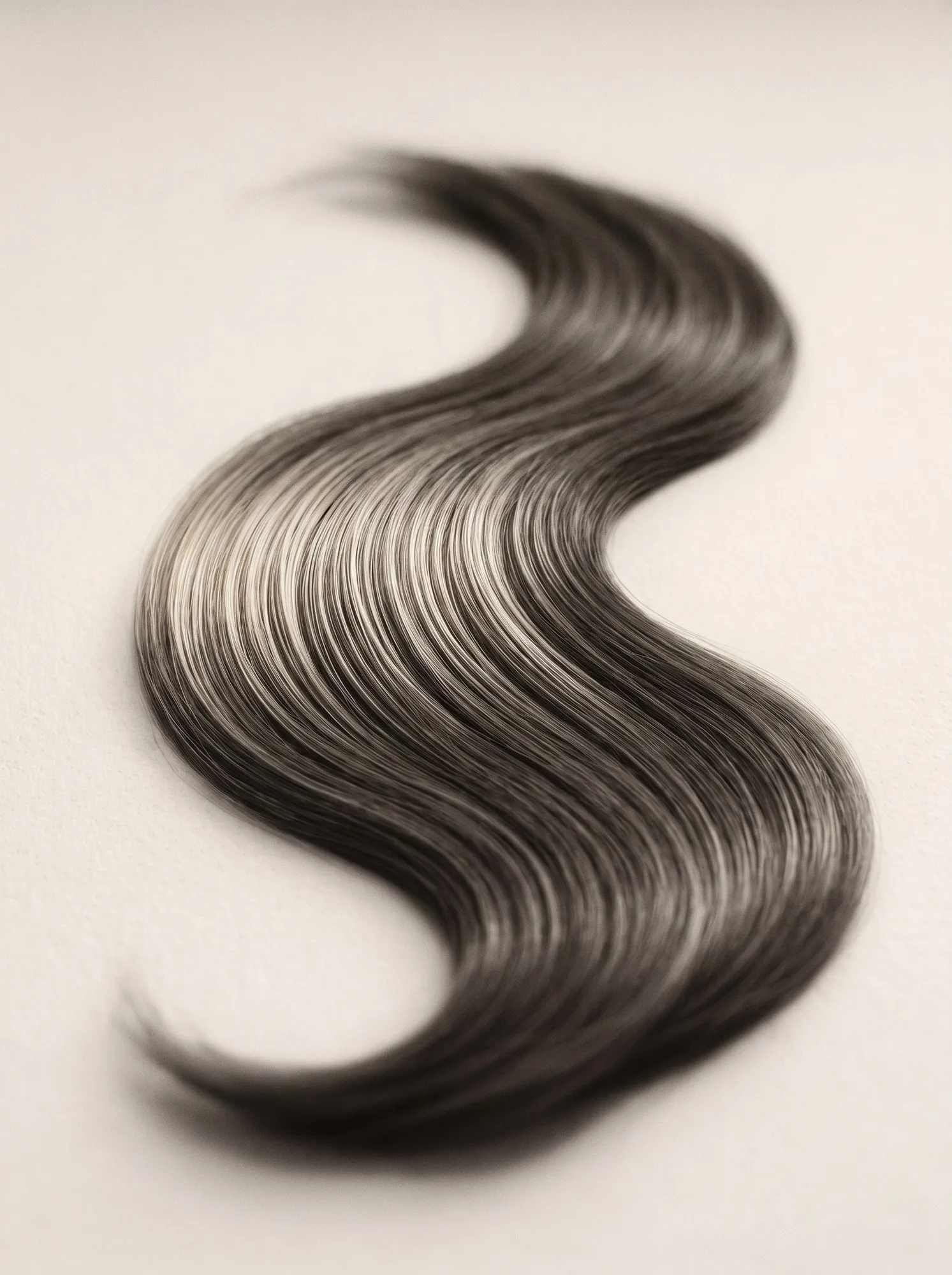 A macro study of smooth, healthy hair catching the light